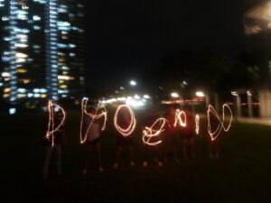 Photo of students using sparklers to 'draw' the word Phoenix taken in the dark during Deepavali celebration. Photo taken by Ian Tan Wei