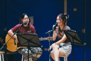 Yi Ann and Shu Juan (YiShun) – Phoenix House Heads AY22/23 performing their self-composed song (Photo Credit: Ethan Ow Yong) 